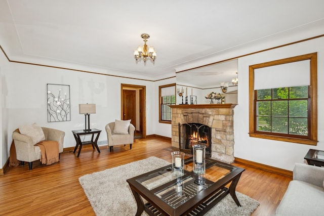 4207 Vincent Ave, Minneapolis, MN 55412 - living area featuring a chandelier, light wood finished floors, a stone fireplace, and ornamental molding