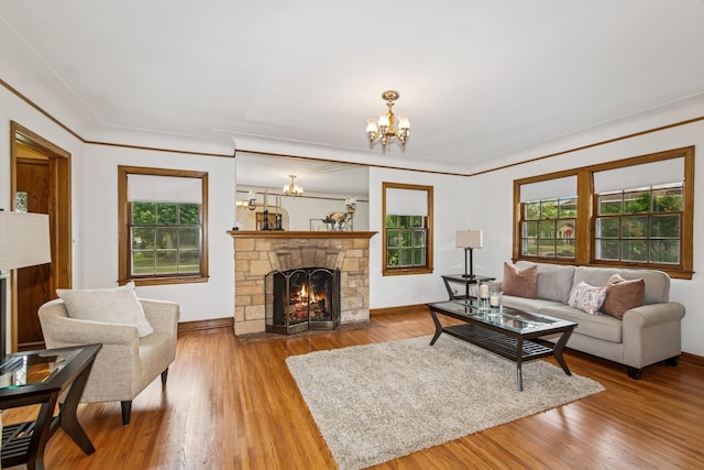4207 Vincent Ave, Minneapolis, MN 55412 - living area with a chandelier, a fireplace, and wood finished floors