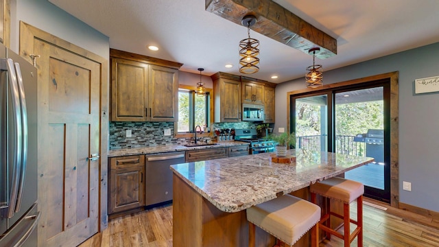 29572 Morgan Rd, Wykoff, MN 55990 - kitchen with appliances with stainless steel finishes, a sink, tasteful backsplash, light wood finished floors, and recessed lighting