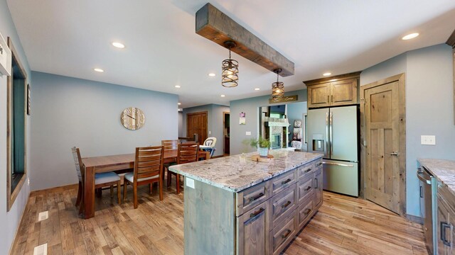 29572 Morgan Rd, Wykoff, MN 55990 - kitchen featuring appliances with stainless steel finishes, recessed lighting, light wood-style flooring, light stone countertops, and a kitchen island