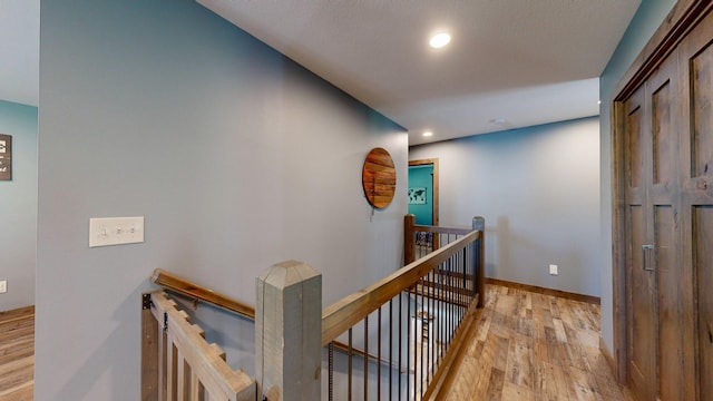 29572 Morgan Rd, Wykoff, MN 55990 - hallway featuring an upstairs landing, light wood finished floors, recessed lighting, and baseboards