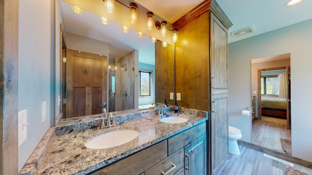 29572 Morgan Rd, Wykoff, MN 55990 - full bathroom with a shower stall, toilet, double vanity, and ensuite bath