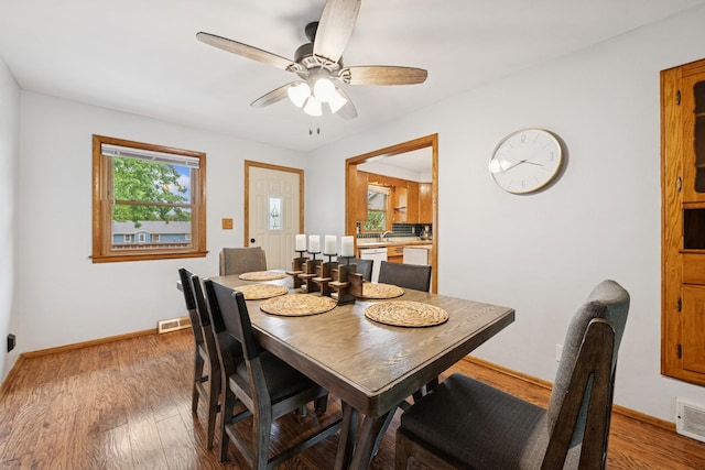 621 Irving Ave NW, Elk River, MN 55330 - dining area with light wood finished floors, baseboards, and a ceiling fan