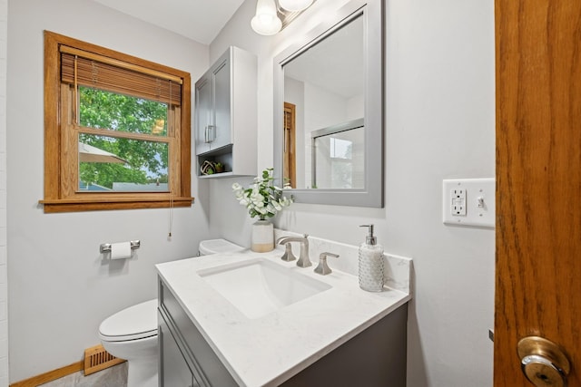 621 Irving Ave NW, Elk River, MN 55330 - full bathroom with toilet, vanity, a shower with door, and baseboards