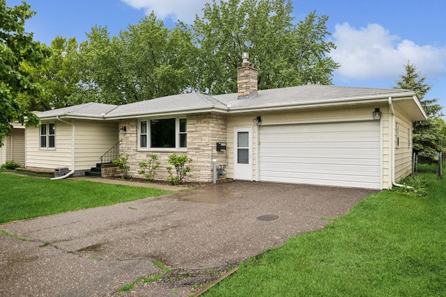 621 Irving Ave NW, Elk River, MN 55330 - single story home with an attached garage, a chimney, a front lawn, driveway, and stone siding