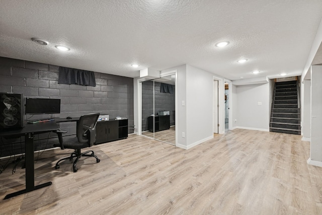 621 Irving Ave NW, Elk River, MN 55330 - office area with a textured ceiling, light wood finished floors, baseboards, concrete block wall, and recessed lighting