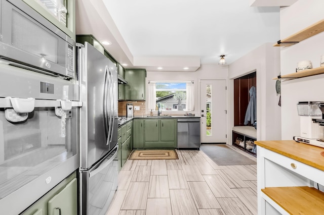 1093 Smith Ave S, West Saint Paul, MN 55118 - kitchen with green cabinets, stainless steel appliances, a sink, recessed lighting, and open shelves
