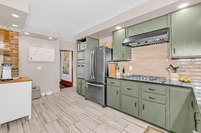 1093 Smith Ave S, West Saint Paul, MN 55118 - kitchen featuring green cabinetry, wall chimney range hood, appliances with stainless steel finishes, dark countertops, and recessed lighting