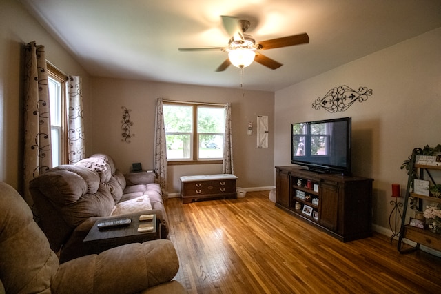 living room featuring ceiling fan, wood finished floors, and baseboards