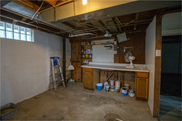 below grade area with concrete block wall
