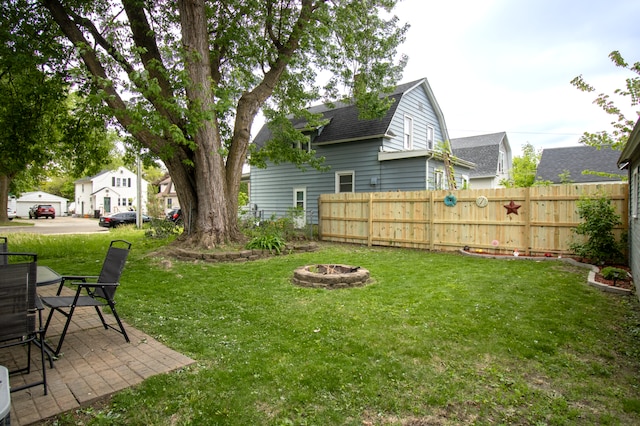 view of yard with a fire pit and a patio area