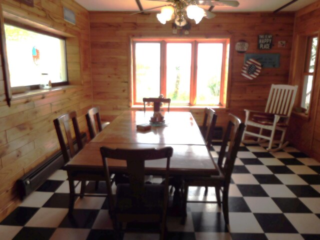 31649 250th Ave, Wendell, MN 56590 - dining space featuring tile patterned floors, wood walls, and ceiling fan