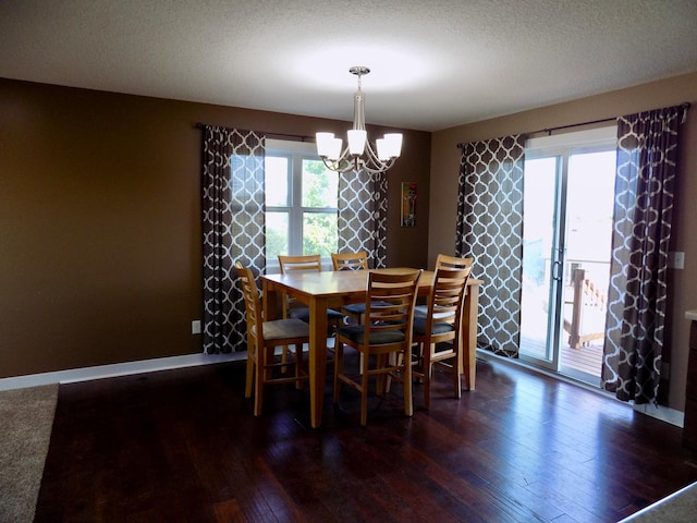 1173 Lone Stone Ct SE, Chatfield, MN 55923 - dining area with a chandelier, dark wood finished floors, baseboards, and a textured ceiling
