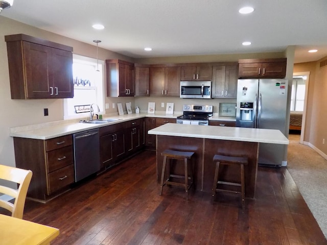 1173 Lone Stone Ct SE, Chatfield, MN 55923 - kitchen featuring appliances with stainless steel finishes, a sink, a kitchen island, a breakfast bar, and light countertops