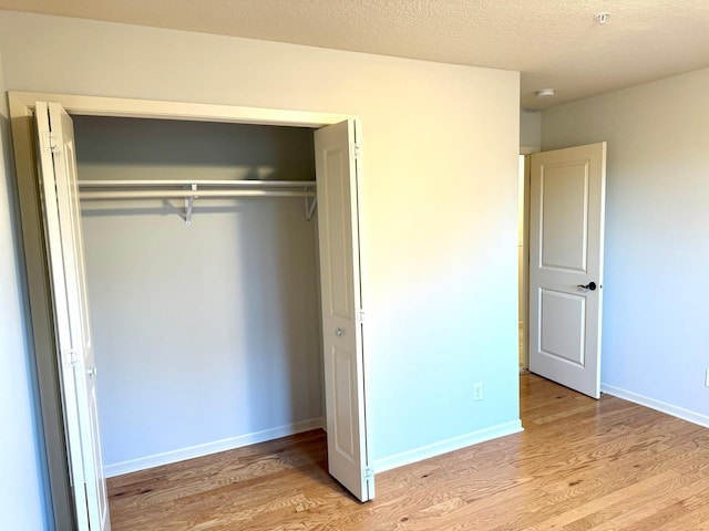 628 20th Ave S, Minneapolis, MN 55454 - unfurnished bedroom with a closet, light wood-type flooring, and baseboards