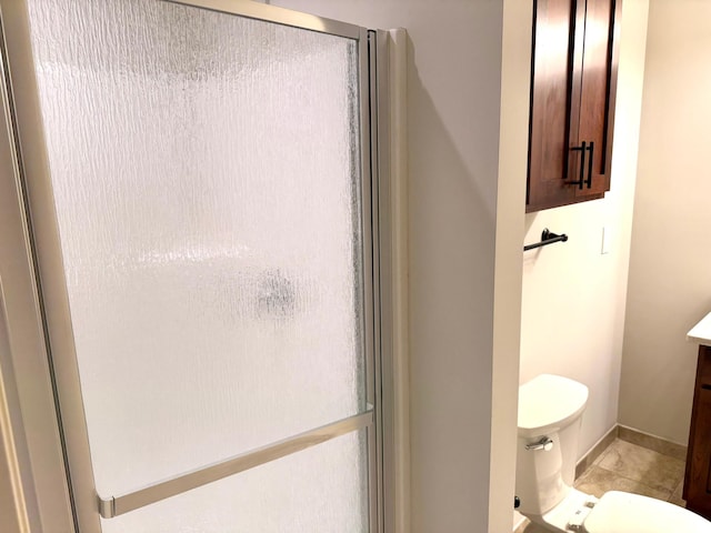 628 20th Ave S, Minneapolis, MN 55454 - bathroom featuring vanity, toilet, tile patterned floors, and a shower with shower door