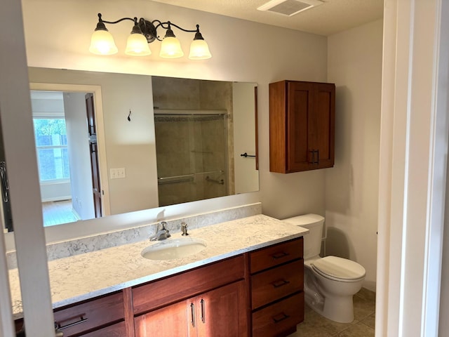 628 20th Ave S, Minneapolis, MN 55454 - full bathroom featuring a stall shower, toilet, tile patterned floors, and vanity