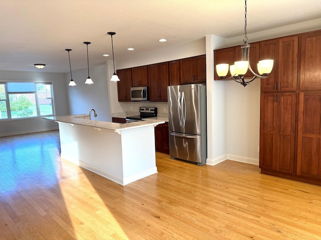628 20th Ave S, Minneapolis, MN 55454 - kitchen featuring stainless steel appliances, light wood finished floors, baseboards, light countertops, and recessed lighting