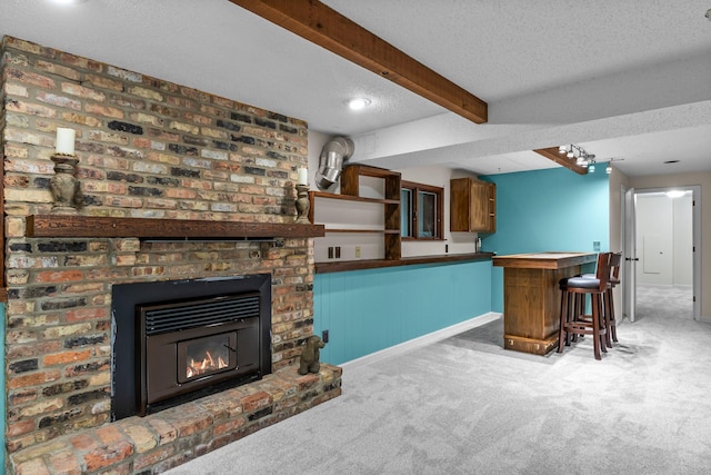 18520 29th Ave N, Plymouth, MN 55447 - living room featuring carpet, a bar, a textured ceiling, beam ceiling, and a brick fireplace