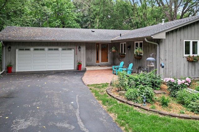 18520 29th Ave N, Plymouth, MN 55447 - view of front of house with an attached garage, driveway, and roof with shingles