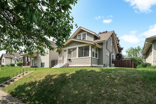 1829 Ross Ave E, Saint Paul, MN 55119 - view of front of house featuring a shingled roof, a sunroom, and stairway