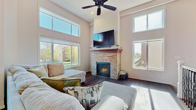 2762 134th St W, Rosemount, MN 55068 - living area featuring a high ceiling, plenty of natural light, ceiling fan, a stone fireplace, and wood finished floors