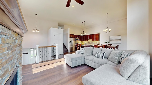 2762 134th St W, Rosemount, MN 55068 - living area with ceiling fan, dark wood-type flooring, a chandelier, recessed lighting, and a stone fireplace