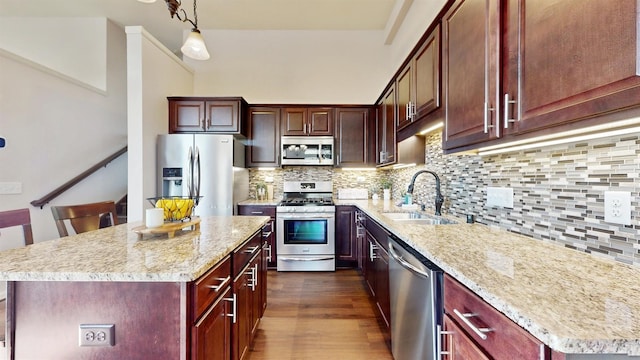 2762 134th St W, Rosemount, MN 55068 - kitchen with appliances with stainless steel finishes, a sink, a kitchen island, dark wood-style floors, and pendant lighting