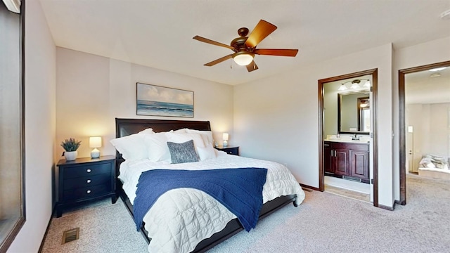 2762 134th St W, Rosemount, MN 55068 - bedroom with light colored carpet, connected bathroom, baseboards, ceiling fan, and a sink