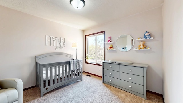 2762 134th St W, Rosemount, MN 55068 - bedroom featuring a crib, baseboards, and carpet flooring