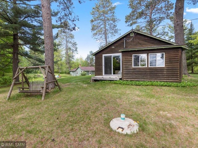 1403 County 5 NW, Hackensack, MN 56452 - back of house featuring log veneer siding and a yard