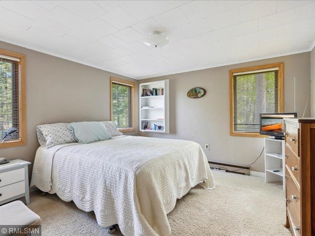 1403 County 5 NW, Hackensack, MN 56452 - carpeted bedroom featuring multiple windows, baseboard heating, crown molding, and baseboards
