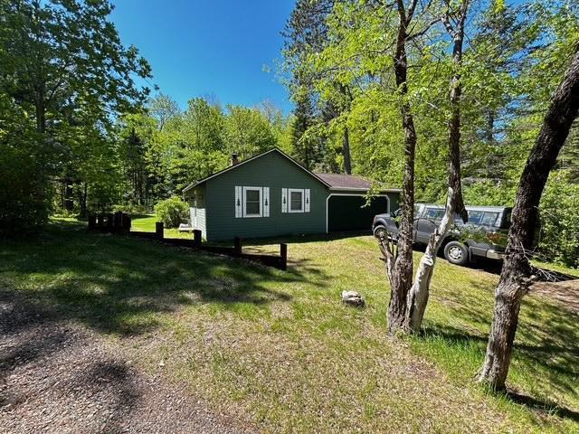 1403 County 5 NW, Hackensack, MN 56452 - view of side of property with a lawn