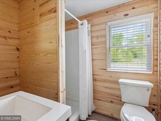 1403 County 5 NW, Hackensack, MN 56452 - full bathroom featuring toilet, a stall shower, and wood walls