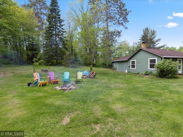 1403 County 5 NW, Hackensack, MN 56452 - view of green lawn featuring an outdoor fire pit