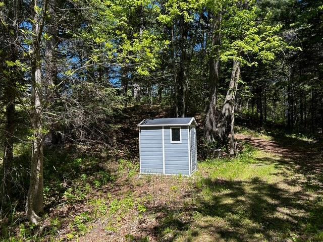 1403 County 5 NW, Hackensack, MN 56452 - view of shed featuring a view of trees