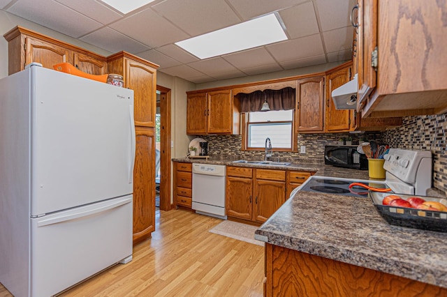 114 Iowa Ave, Hoffman, MN 56339 - kitchen with white appliances, a sink, under cabinet range hood, light wood-style floors, and brown cabinets