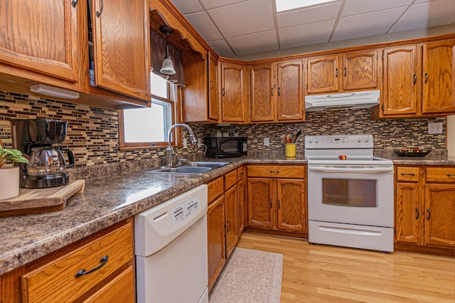 114 Iowa Ave, Hoffman, MN 56339 - kitchen with white appliances, under cabinet range hood, a sink, brown cabinets, and a paneled ceiling