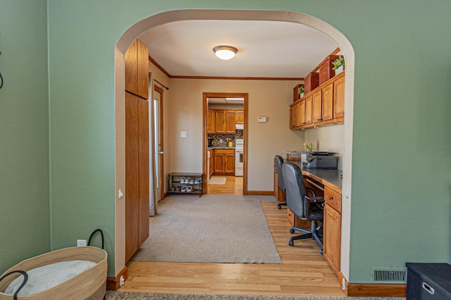 114 Iowa Ave, Hoffman, MN 56339 - office with light wood finished floors, arched walkways, built in study area, ornamental molding, and baseboards