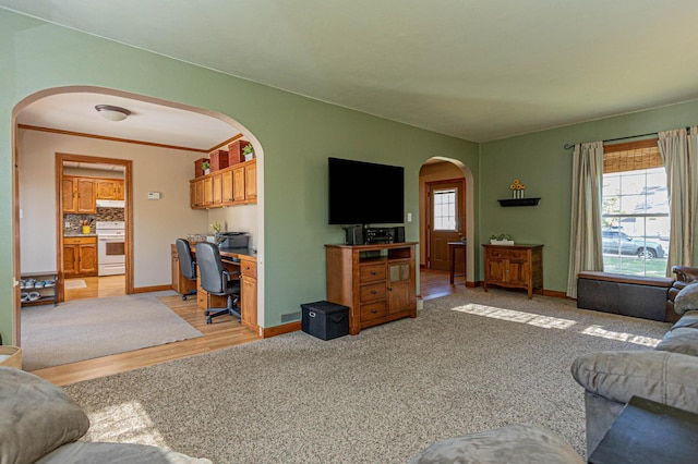 114 Iowa Ave, Hoffman, MN 56339 - living area with arched walkways, an office area, baseboards, and light wood-style flooring