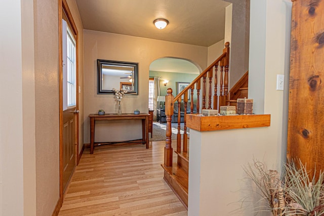 114 Iowa Ave, Hoffman, MN 56339 - corridor with arched walkways, light wood-style floors, stairs, and baseboards