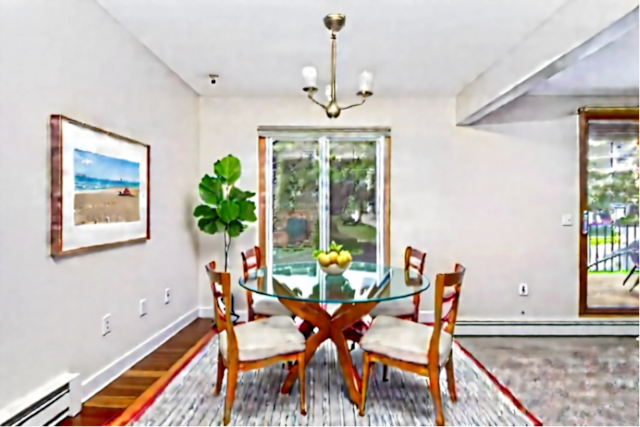 6415 York Ave S Unit 105, Edina, MN 55435 - dining area with baseboard heating, wood finished floors, baseboards, and plenty of natural light