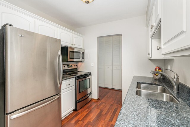6415 York Ave S Unit 105, Edina, MN 55435 - kitchen with stainless steel appliances, a sink, white cabinets, dark wood-style flooring, and dark stone countertops