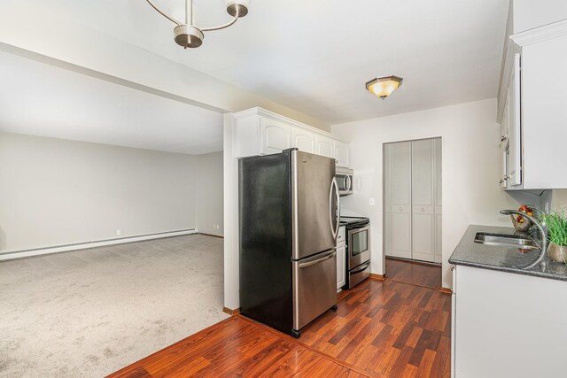 6415 York Ave S Unit 105, Edina, MN 55435 - kitchen featuring appliances with stainless steel finishes, a sink, white cabinets, a baseboard heating unit, and baseboards