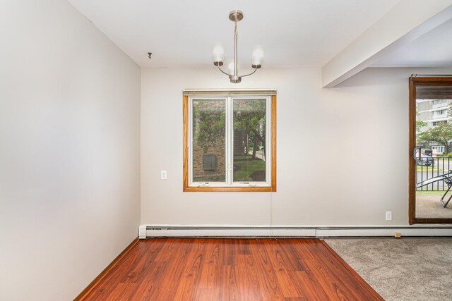 6415 York Ave S Unit 105, Edina, MN 55435 - spare room with a baseboard radiator, wood finished floors, and a chandelier