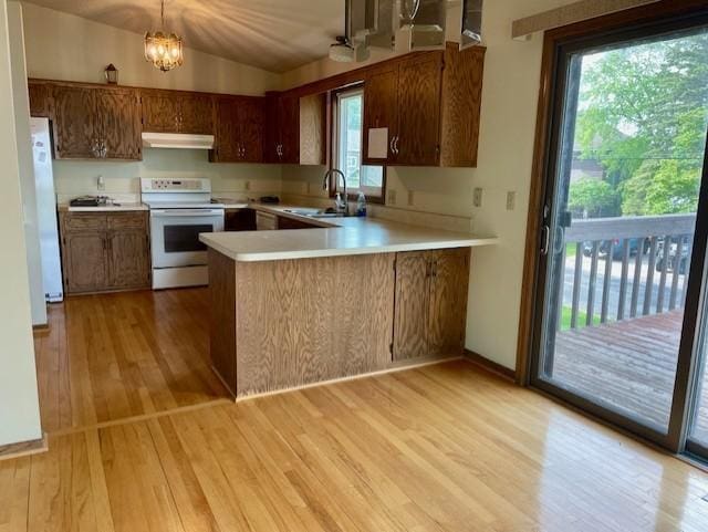 4924 Three Points Blvd, Mound, MN 55364 - kitchen featuring white appliances, a sink, light wood-type flooring, light countertops, and under cabinet range hood