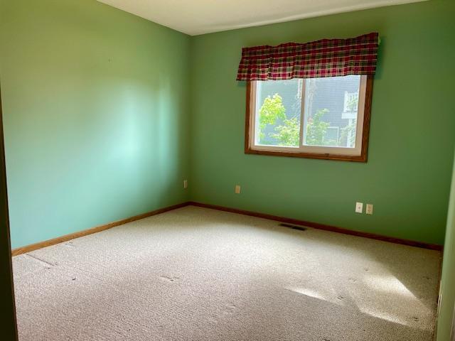 4924 Three Points Blvd, Mound, MN 55364 - spare room featuring carpet flooring and baseboards