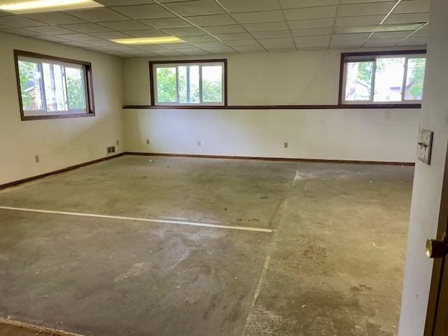 4924 Three Points Blvd, Mound, MN 55364 - spare room with unfinished concrete floors, a drop ceiling, baseboards, and healthy amount of natural light