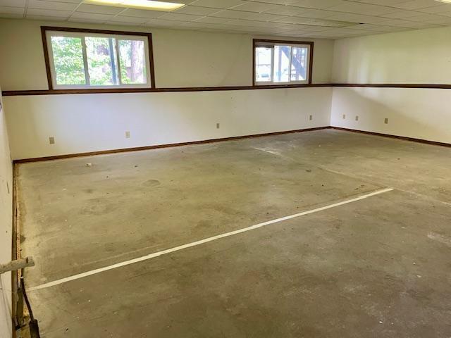 4924 Three Points Blvd, Mound, MN 55364 - spare room with unfinished concrete flooring, a paneled ceiling, and baseboards