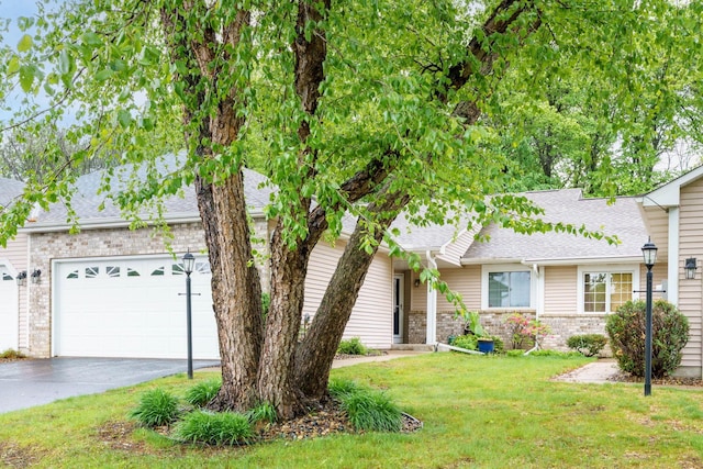 532 Sterling St S, Maplewood, MN 55119 - view of front of home with asphalt driveway, a front lawn, an attached garage, and roof with shingles
